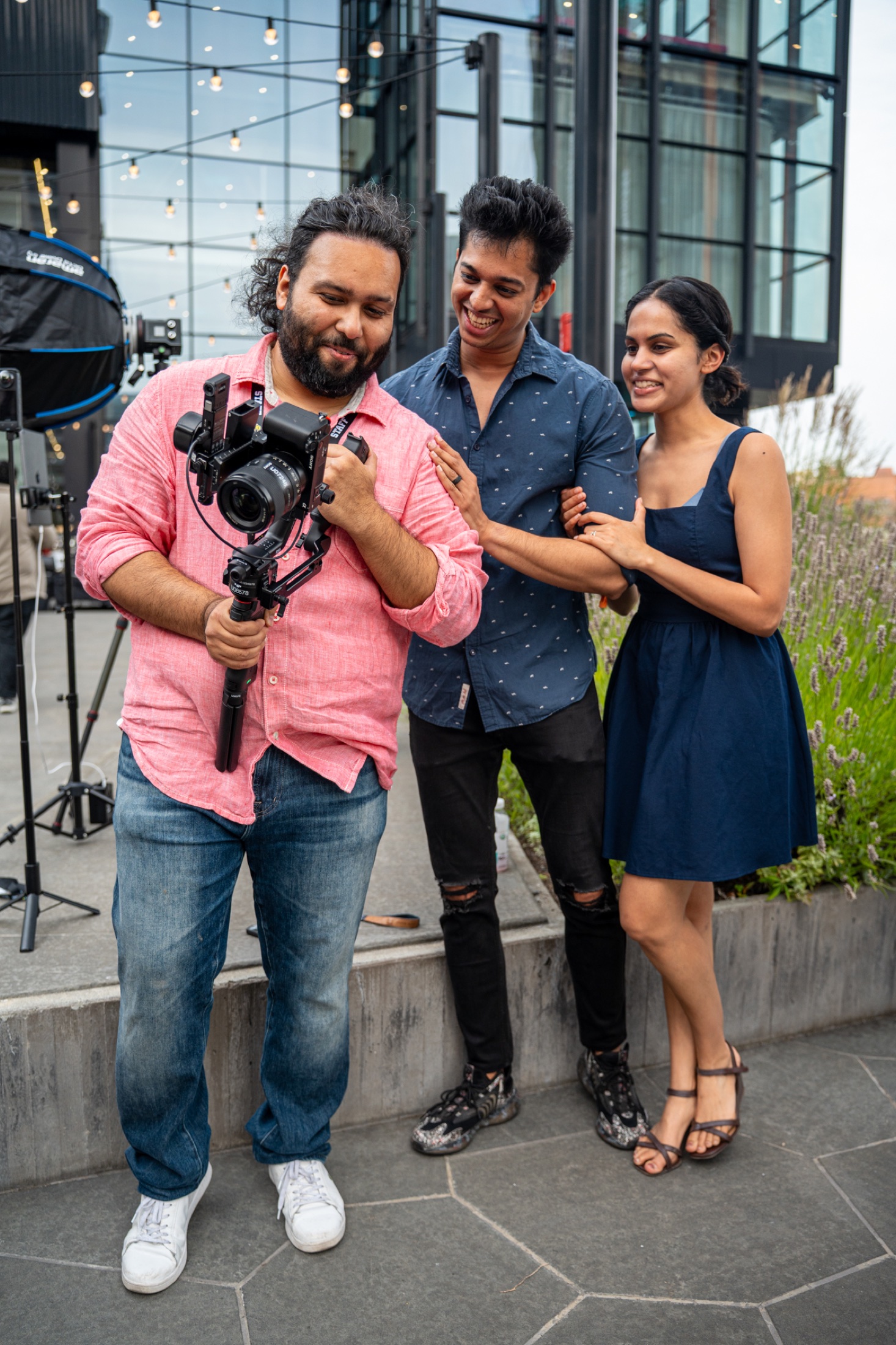 Dennis Dey holding a camera on a production set