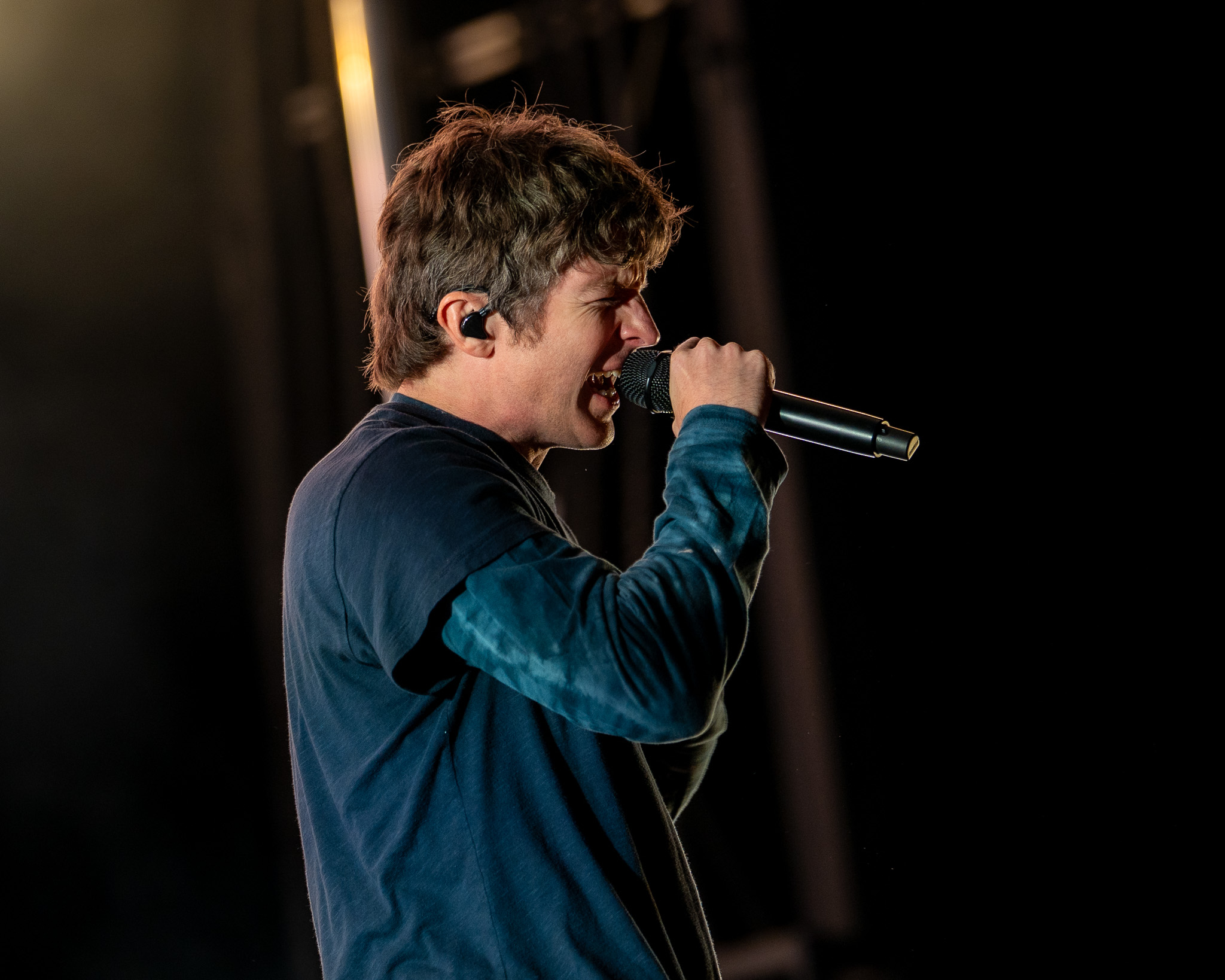 Turnstile vocalist Brendan Yates leaning toward the crowd