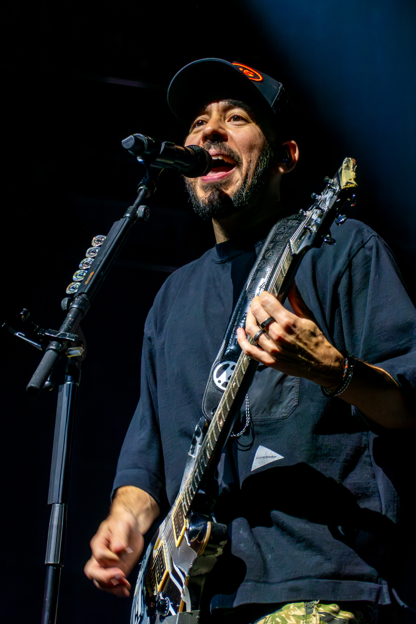 Linkin Park guitarist performing under arena light